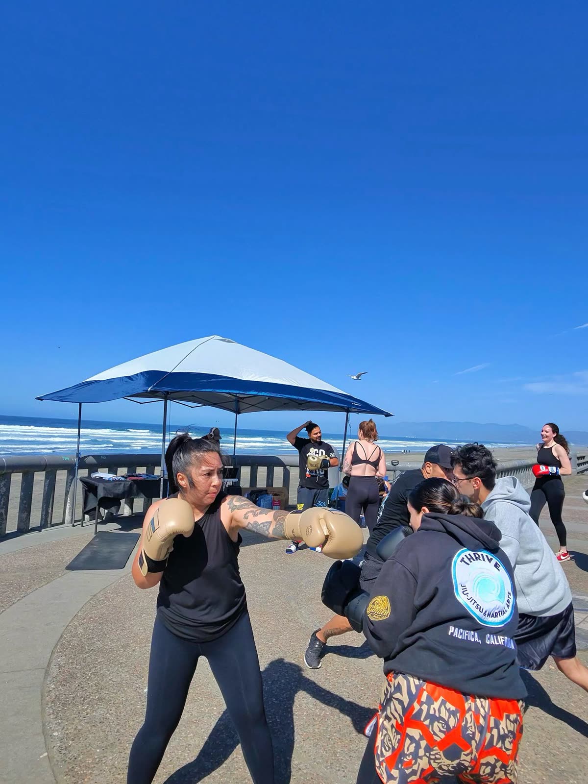 Outdoor boxing class at the beach with group of students